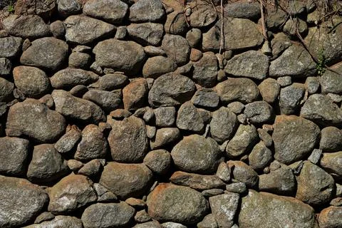 A background image of a natural stone wall texture. Stock Photos