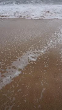 Background image pattern of sea shore with sea waves on sand Foto stock