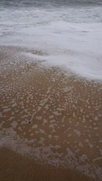 Background image pattern of sea shore with sea waves on sand Stock Photos