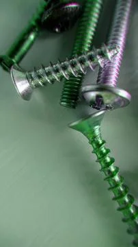 Background image of screws bolts of different sizes on the table Stock Photos