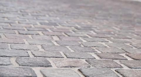 Background image of set of granite Grey brick stone street road. Light sidewa Photos