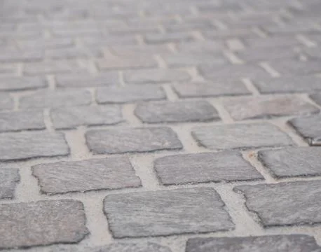 Background image of set of granite Grey brick stone street road. Light sidewa Stock-Fotos