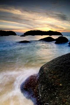 Background image, soft wave hitting the rock on the tropical beach over magic 写真素材