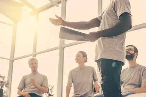 Background image of a speaker reading a report to a group of students. Stock Photos