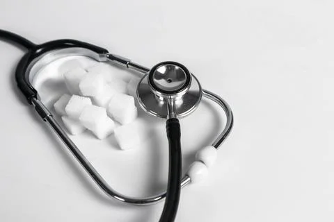 Background image of sugar cubes and medical stethoscope health care Stock Photos