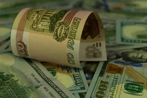 Background image of US dollars and one hundred Russian rubles Stock Photos