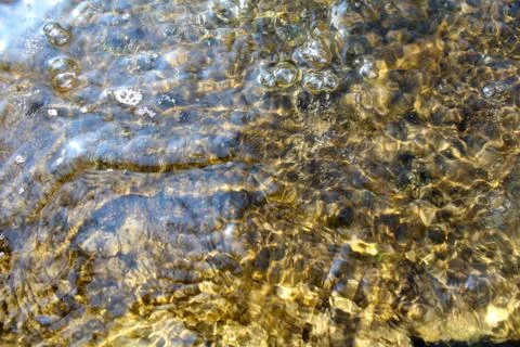 Background image. Waves and bubbles on the water. Stock Photos