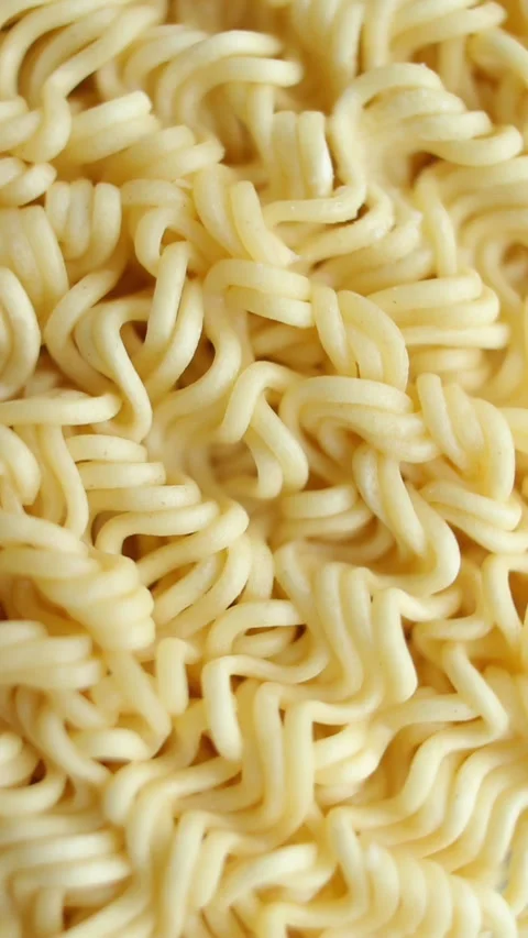 Background of instant noodles rotating close up, top view. Vertical video. Stock Footage 269309619