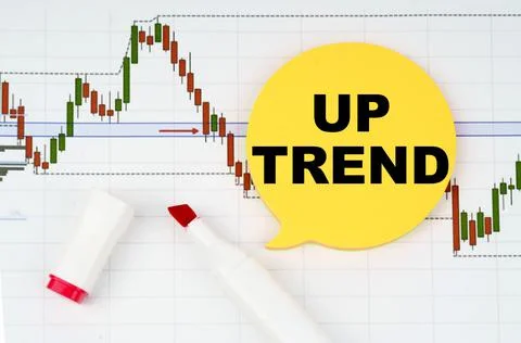 On the background of interactive forex charts there is a marker and a sticker Stock Photos