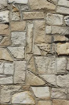 Background of irregular stones set in wall Stock Photos