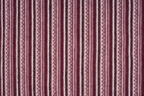 Background of a knitted textile material with pattern of vertical lines. Stock Photos