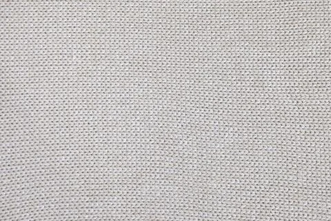 Background of knitted texture of fabric of pale color or knitwear closeup Stock Photos