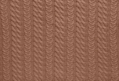 Background of knitting pattern. Mocha Mousse, Color of the Year 2025. Stock Photos