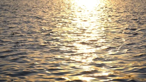 Background of lake water surface with ripples and sunlight at sunset Video stock 128238083