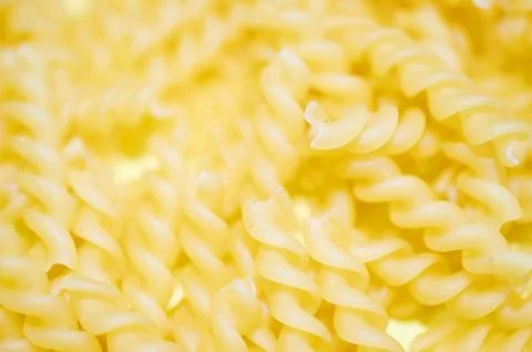 Background layout from the pasta. Spirals Stock Photos