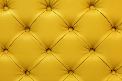 Background of leather yellow sofa, stitched buttons. Stock Photos