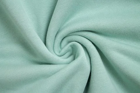 Background of light green fabric sample from above view Stock Photos