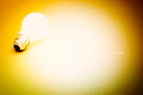 Background with lit lightbulb Stock Photos