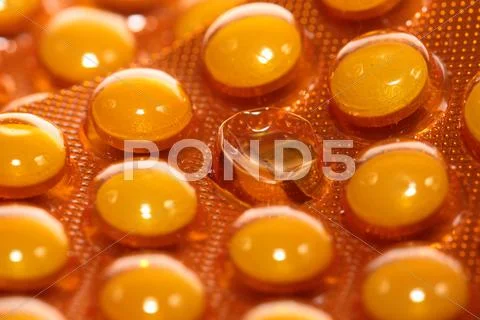 Background from macro of yellow medicine pills Stock Photos