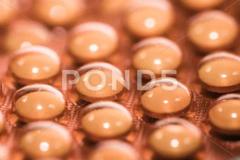 Background from macro of yellow medicine pills Stock Photos