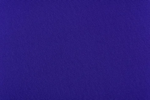 Background made of blue material. Fabric for sewing clothes in a dark shade. Stock Photos