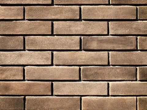 The background is made of brown brickwork Stock Photos