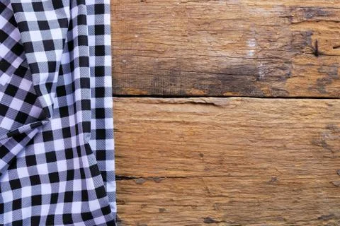 The background made from checkered napkin on old wooden table Stock Photos
