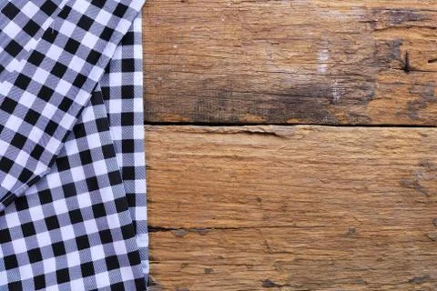 The background made from checkered napkin on old wooden table Stock Photos