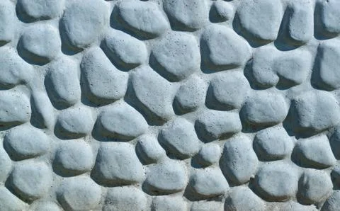 Background made of a closeup of a wall with pebbles Stock Photos