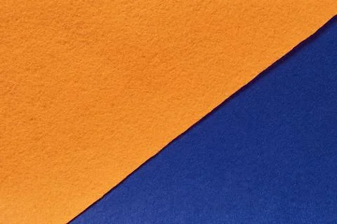 The background is made of felt in blue and orange colors Stock Photos