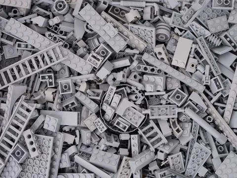 Background made of gray Lego blocks, bricks and pieces. Stock Photos