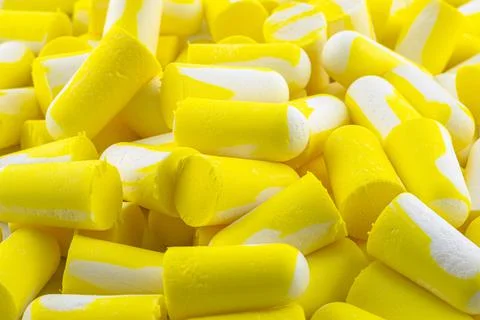Background made of macro shots of multiple earplugs in yellow and white for n Foto stock