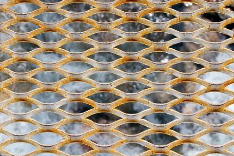 The background is made of metal mesh Stock Photos