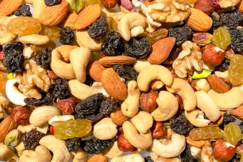 Background made of mixed nuts and raisins. Assorted nuts and dry grapes Stock Photos