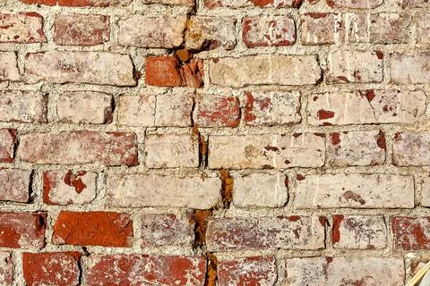 The background is made of old old red brick and peeling plaster Stock Photos