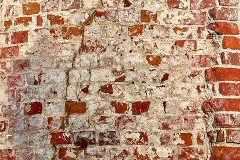 The background is made of old old red brick and peeling plaster Stock Photos