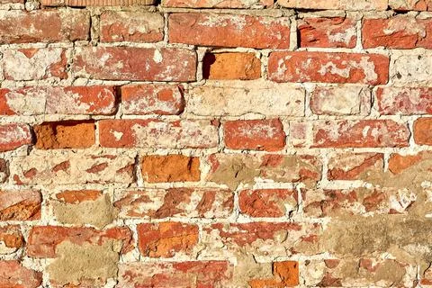 The background is made of old old red brick and peeling plaster Stock Photos