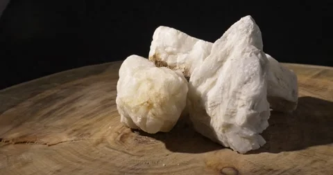 Background made from pieces of white natural quartz on a wooden slab. Minerals Stock Footage 275189358
