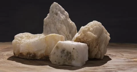 Background made from pieces of white natural quartz on a wooden slab. Minerals Stock Footage 275576587