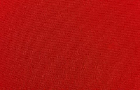 The background is made of red material. Fabric for sewing clothes in a dark s Stock Photos