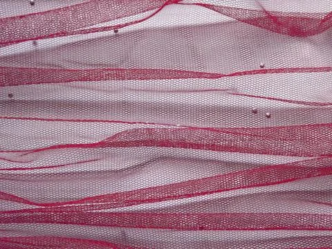 Background made of red translucent fabric on a white base Foto stock