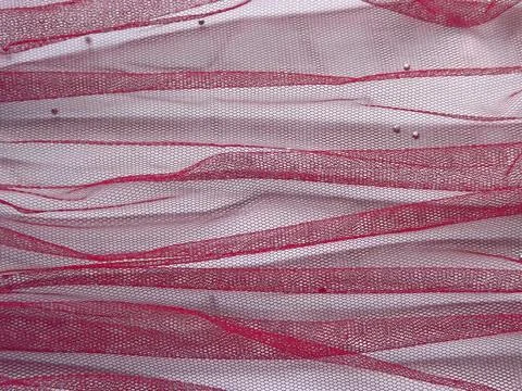Background made of red translucent fabric on a white base Foto stock