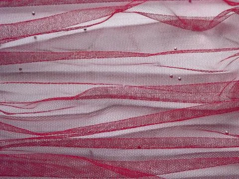 Background made of red translucent fabric on a white base Foto stock