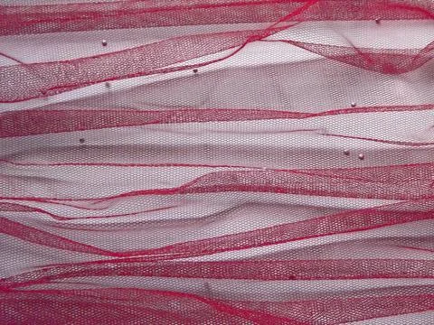 Background made of red translucent fabric on a white base Foto stock