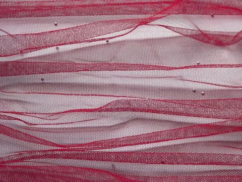 Background made of red translucent fabric on a white base Foto stock