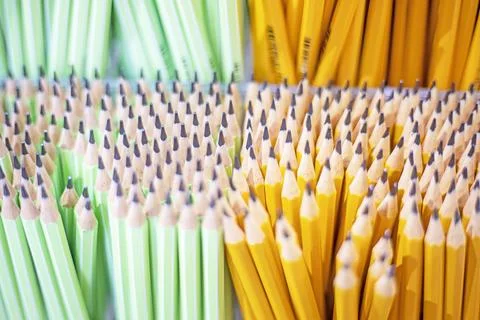 Background made of simple hostro sharpened pencils in yellow and light gree.. Stock Photos
