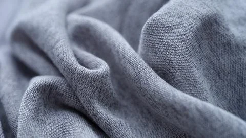 Background made of soft gray marl jersey fabric with folds Stock Photos