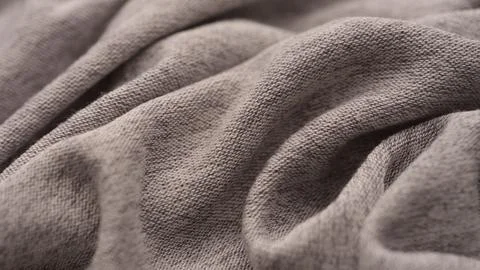 Background made of soft gray marl jersey fabric with folds. Close-up Stock Photos