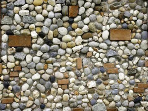 Background made of a wall with pebbles Stock Photos