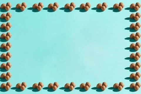 Background made from walnuts on the blue background Stock Photos